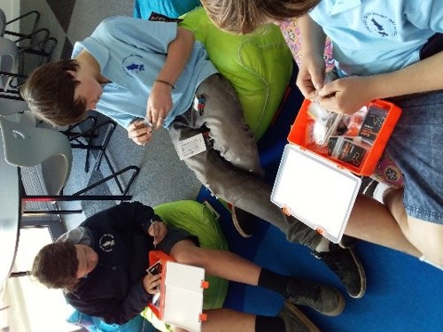 Image of a three primary school males setting up their circuits